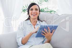 Smiling brunette with tablet pc