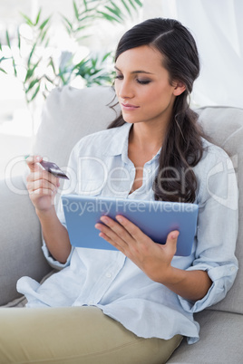 Attractive brunette using her credit card to buy online