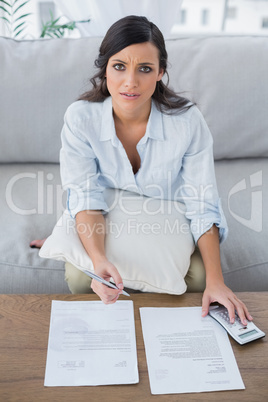 Serious woman checking her bills