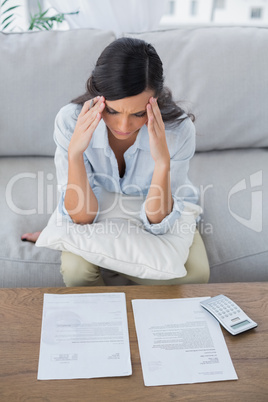 Concentrated woman checking her bills
