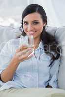 Cheerful attractive brunette drinking white wine