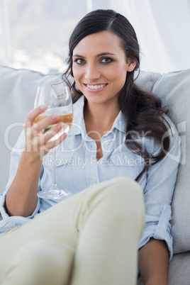 Seductive brunette drinking white wine