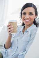 Happy seductive brunette holding coffee mug