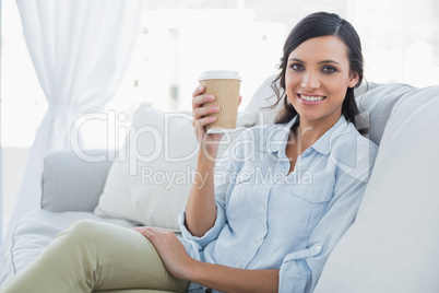 Cheerful seductive brunette having coffee