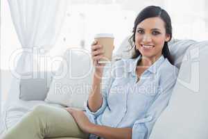 Cheerful seductive brunette having coffee