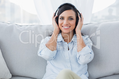 Smiling brunette listening to music