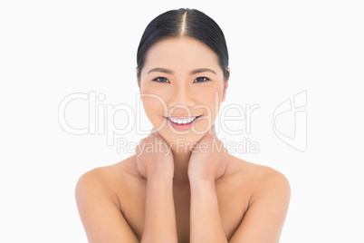 Smiling natural model posing touching her neck