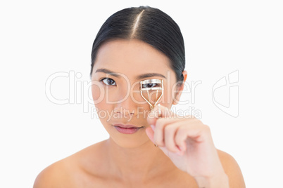 Natural model using eyelash curler