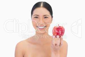 Smiling natural brunette holding red apple