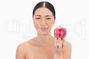 Relaxed natural brunette holding red apple