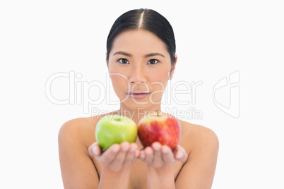 Content natural brunette holding apples in both hands