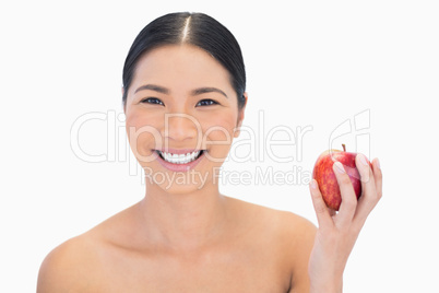 Cheerful black haired model having red apple