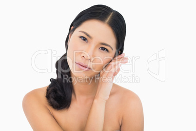 Sensual dark haired model touching her cheek