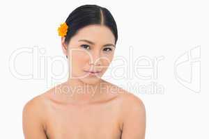 Sensual dark haired model with flower in hair