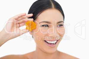 Cheerful natural black haired model holding orange flower