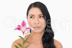 Pretty natural brown haired model posing with lily