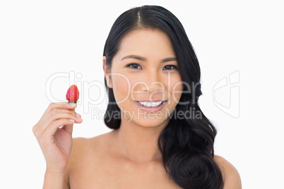 Cheerful natural brown haired model with strawberry