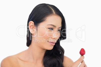 Happy gorgeous brown haired model with strawberry