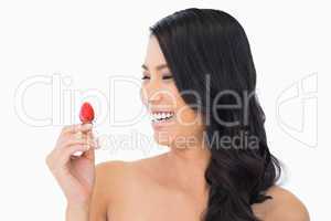 Happy natural brown haired model with strawberry