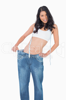 Smiling sexy woman wearing too big pants