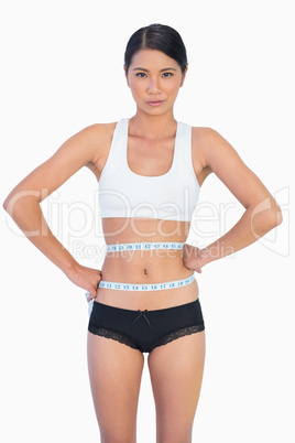 Slim woman measuring her waist