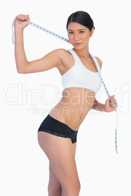 Slim woman holding her measuring tape