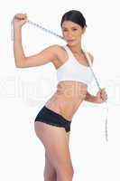 Slim woman holding her measuring tape