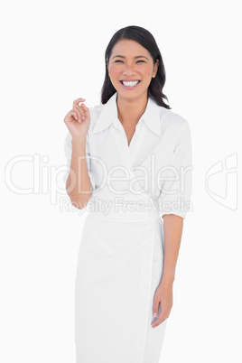 Cheerful dark haired model with classy dress posing