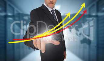 Businessman touching red and yellow growth lines with world map