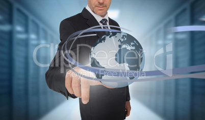 Businessman touching world on futuristic interface with swirling