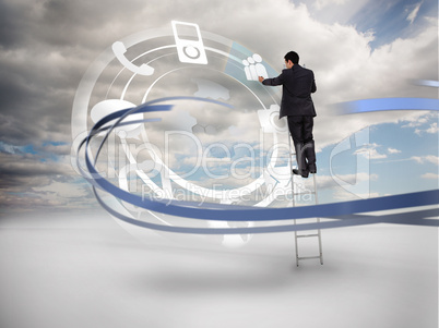 Businessman on ladder touching wheel interface of applications