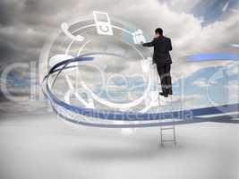 Businessman on ladder touching wheel interface of applications