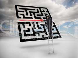 Businessman on ladder drawing red line through qr code