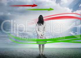 Businesswoman looking at red and green arrows