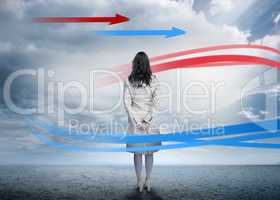 Businesswoman looking at red and blue arrows
