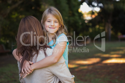 Child looking over her mothers shoulder