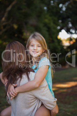 Mother holding her daughter in arms