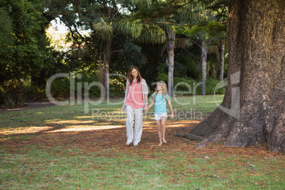 Mother and daugther walking in a park