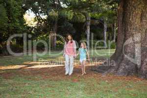 Mother and daugther walking in a park