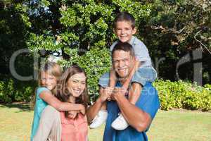 Happy family with children on their shoulders