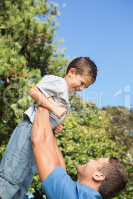Father lifting up his son