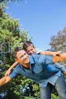 Son lying on his fathers back