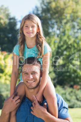 Girl sitting on her dads shoulder