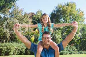 Daughter sitting on dads shoulder