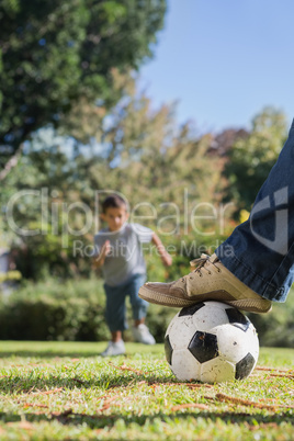 Boy running towards the football