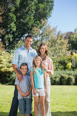 Family standing in the countryside