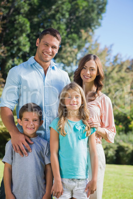 Happy family standing in the countryside