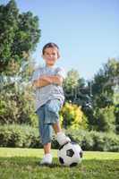 Young boy posing with football