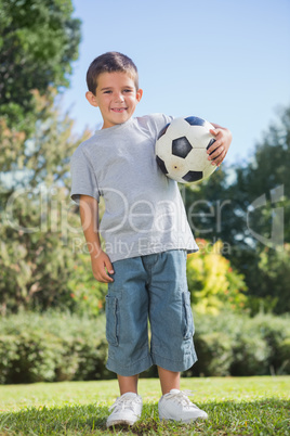 Young boy holding football