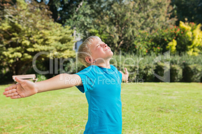 Boy stretching his arms and enjoying the sun